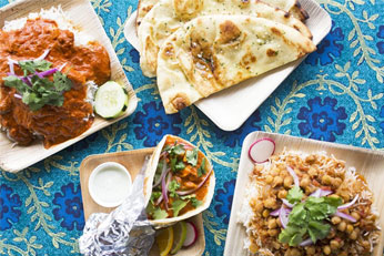 4 different meals on a blue table cloth